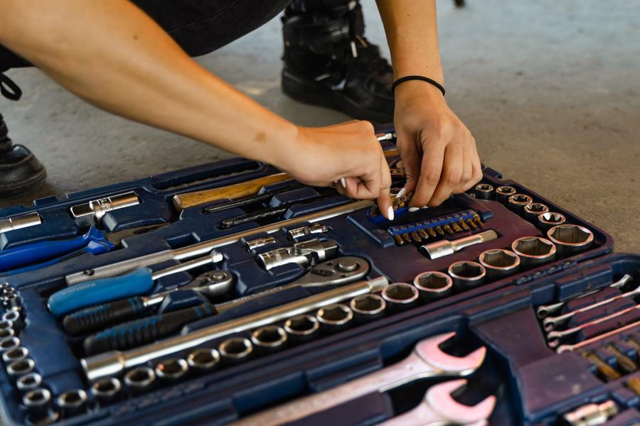 Tradesperson picking a socket from a well-organised toolbox